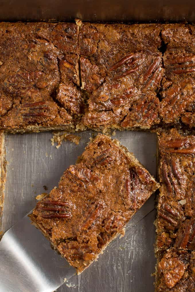 Maple Pecan Squares - Ooey gooey YUM! This easy bar recipe is a cross between a butter tart and pecan pie. Prepare to lick your fingers from this mouthwatering dessert.