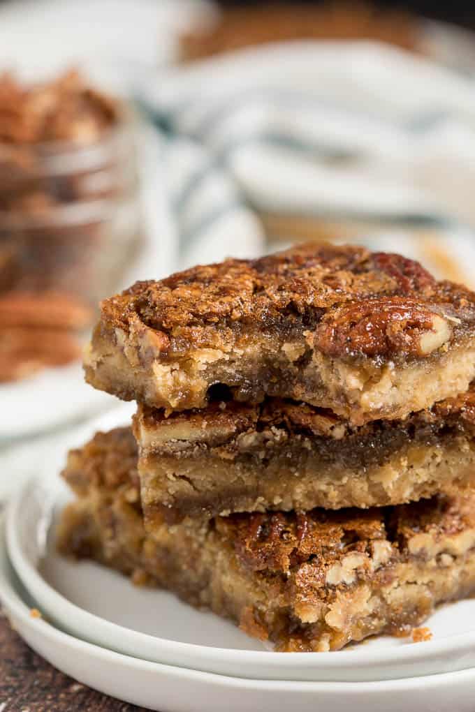 Maple Pecan Squares - Ooey gooey YUM! This easy bar recipe is a cross between a butter tart and pecan pie. Prepare to lick your fingers from this mouthwatering dessert.