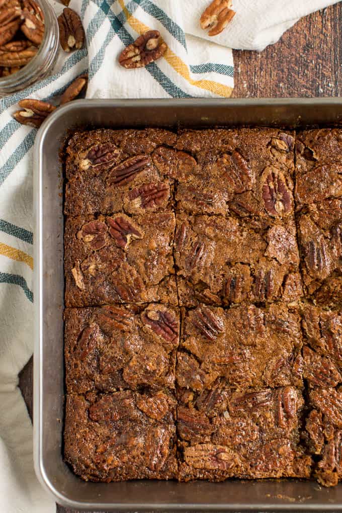 Maple Pecan Squares - Ooey gooey YUM! This easy bar recipe is a cross between a butter tart and pecan pie. Prepare to lick your fingers from this mouthwatering dessert.