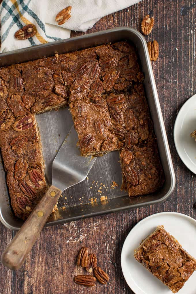 Maple Pecan Squares - Ooey gooey YUM! This easy bar recipe is a cross between a butter tart and pecan pie. Prepare to lick your fingers from this mouthwatering dessert.