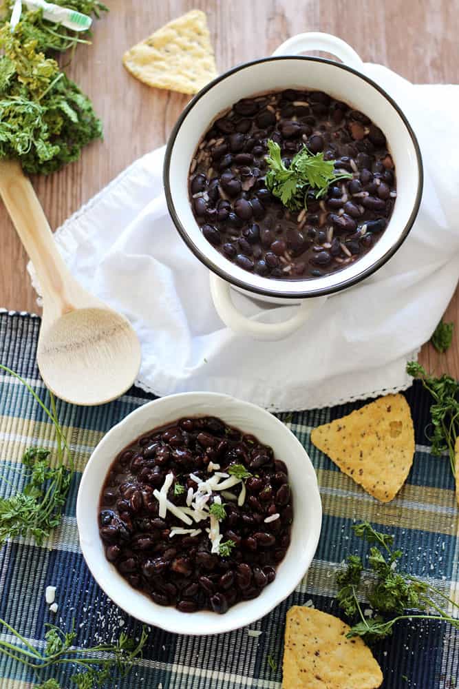 Slow Cooker Black Beans - Make the best dried black beans in the Crockpot! This bean recipe requires no soaking and simmers all day while you're at work for the easiest Taco Tuesday side dish.