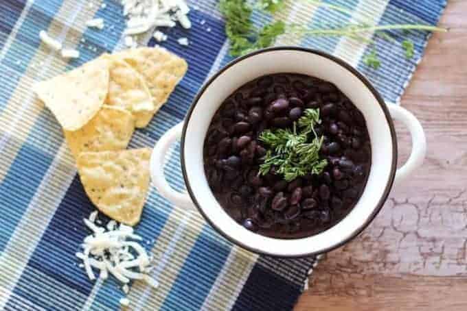 Slow Cooker Black Beans - Make the best dried black beans in the Crockpot! This bean recipe requires no soaking and simmers all day while you're at work for the easiest Taco Tuesday side dish.