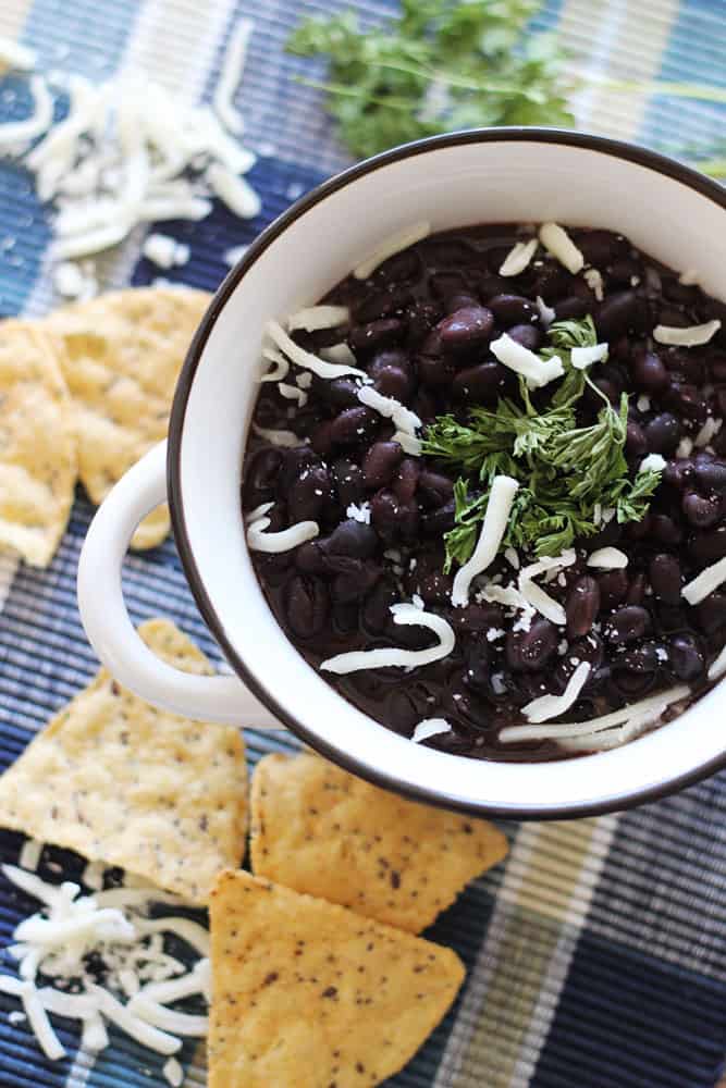 Slow Cooker Black Beans - Make the best dried black beans in the Crockpot! This bean recipe requires no soaking and simmers all day while you're at work for the easiest Taco Tuesday side dish.