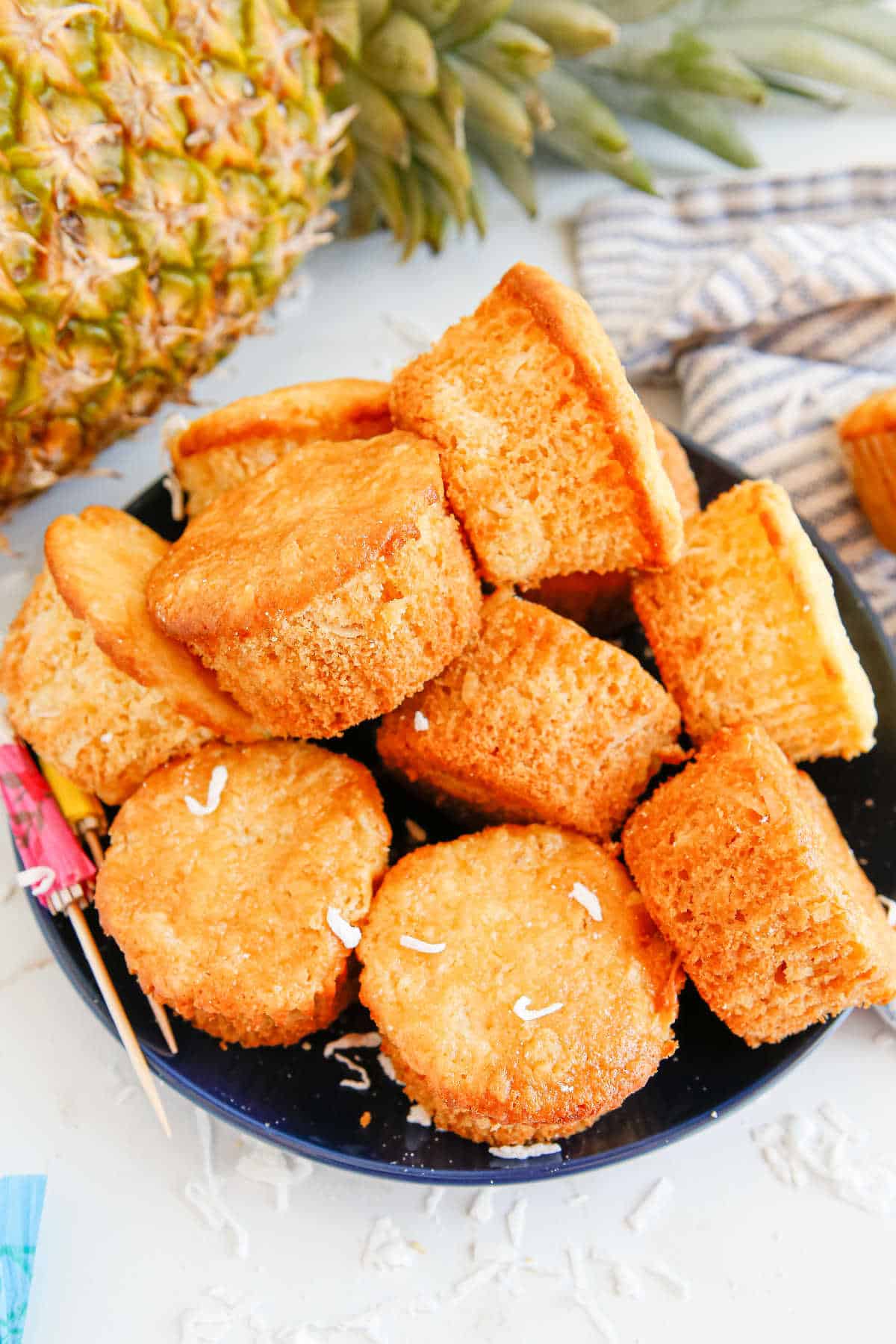 Pina colada muffins piled on a plate.