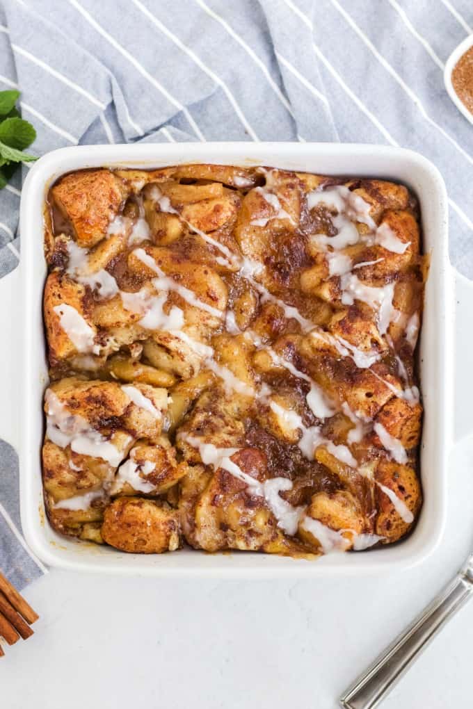 Apple Cinnamon Bun Breakfast Casserole - A sweet way to start your day and feed your guests! It's made with cinnamon buns + apple pie filling for a mouthwatering breakfast casserole you'll make again and again.