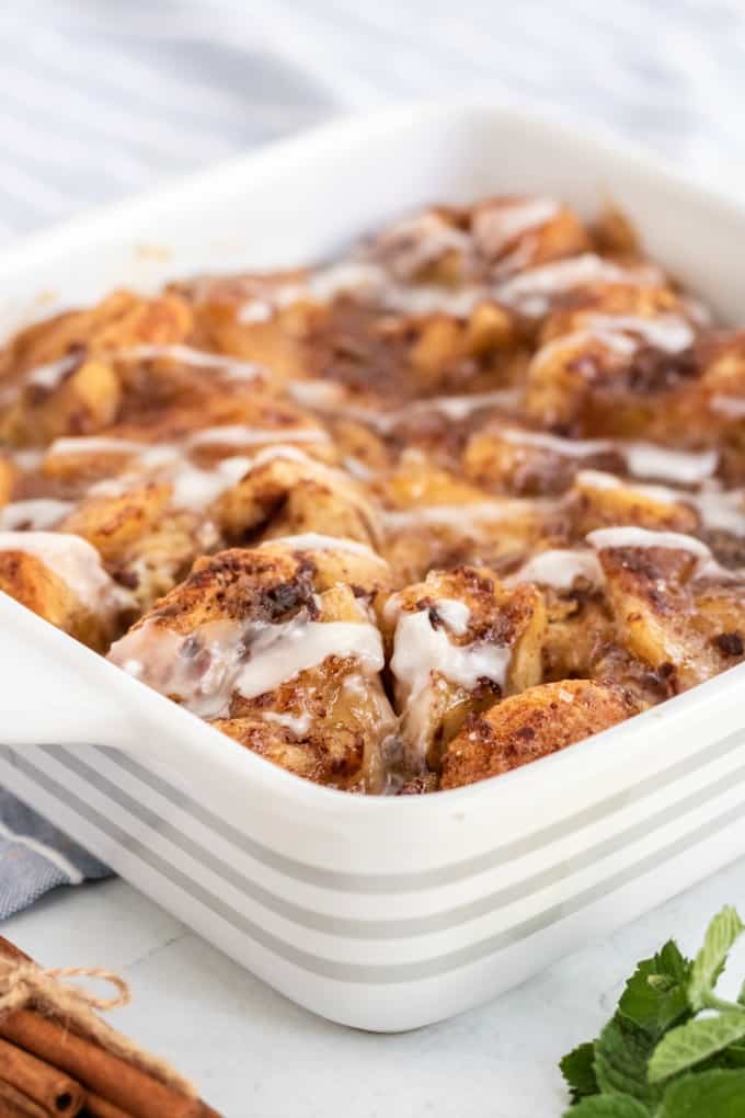 Apple Cinnamon Bun Breakfast Casserole - A sweet way to start your day and feed your guests! It's made with cinnamon buns + apple pie filling for a mouthwatering breakfast casserole you'll make again and again.