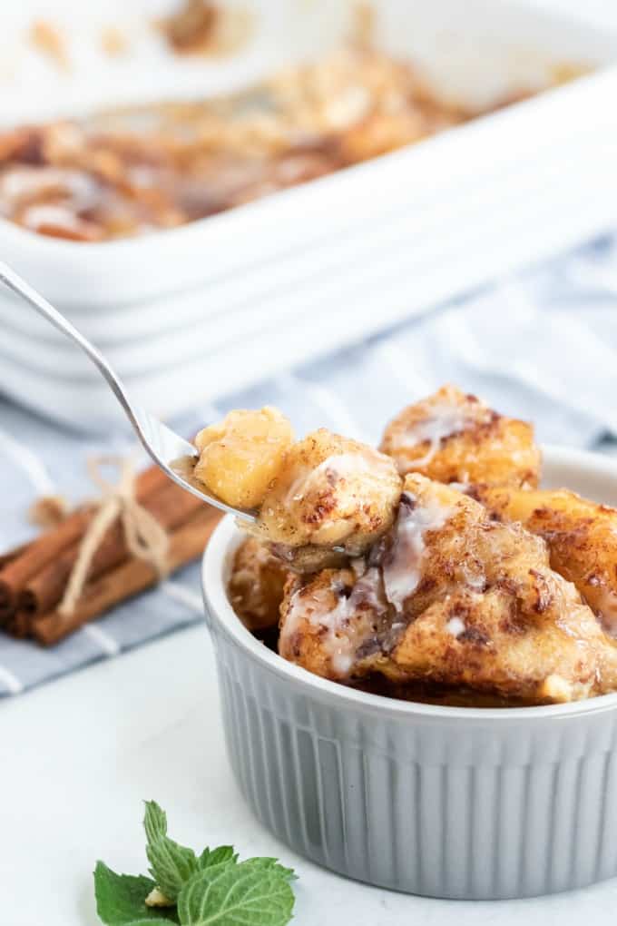 Apple Cinnamon Bun Breakfast Casserole - A sweet way to start your day and feed your guests! It's made with cinnamon buns + apple pie filling for a mouthwatering breakfast casserole you'll make again and again.
