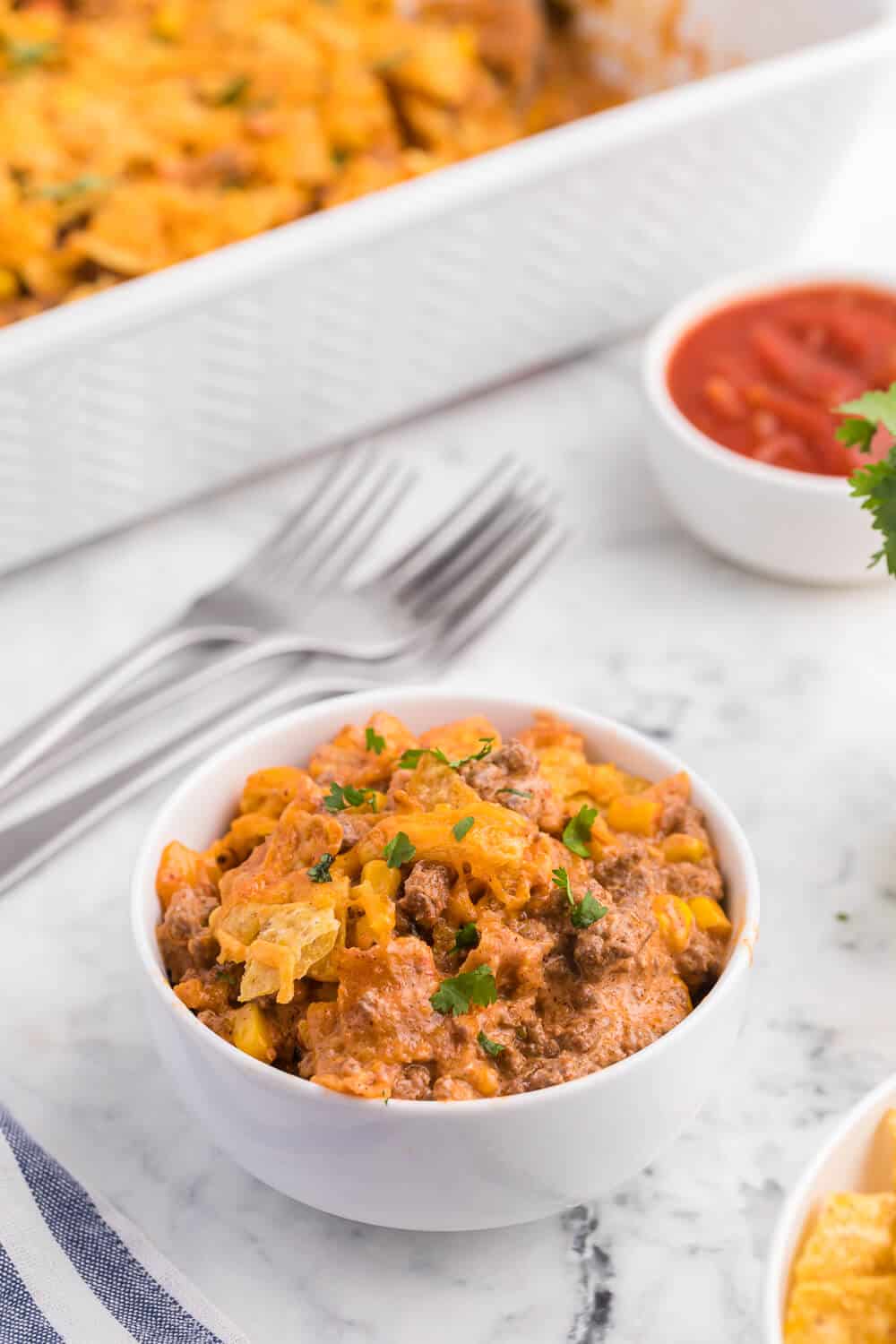 Beef nacho bake served in a white bowl.