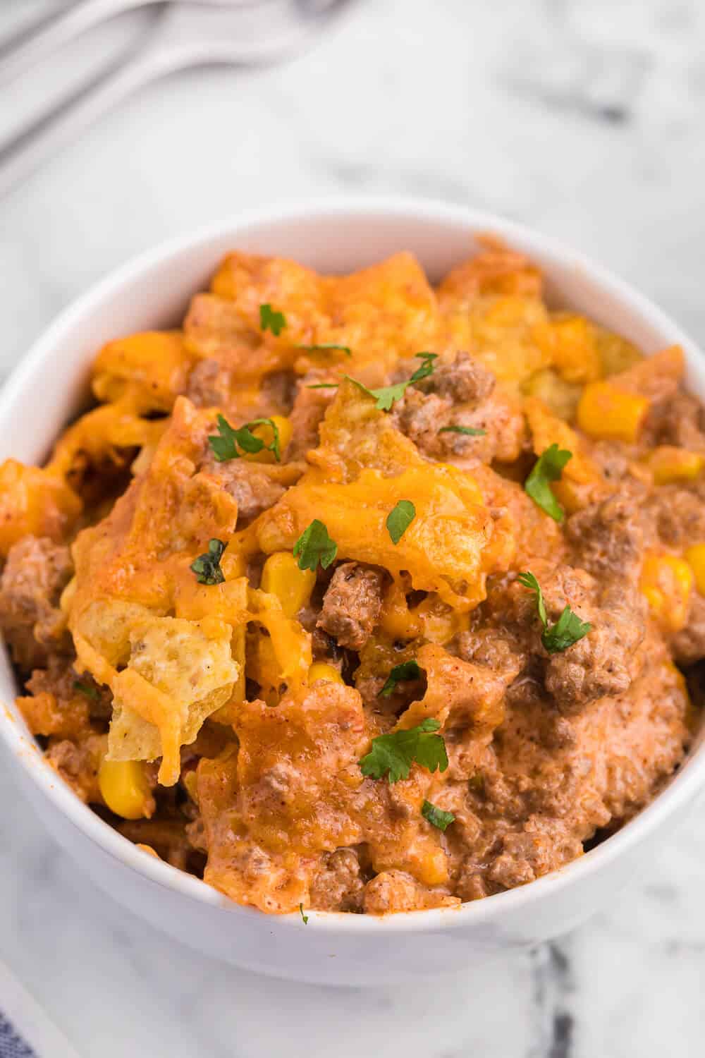 Beef nacho bake in a white bowl.