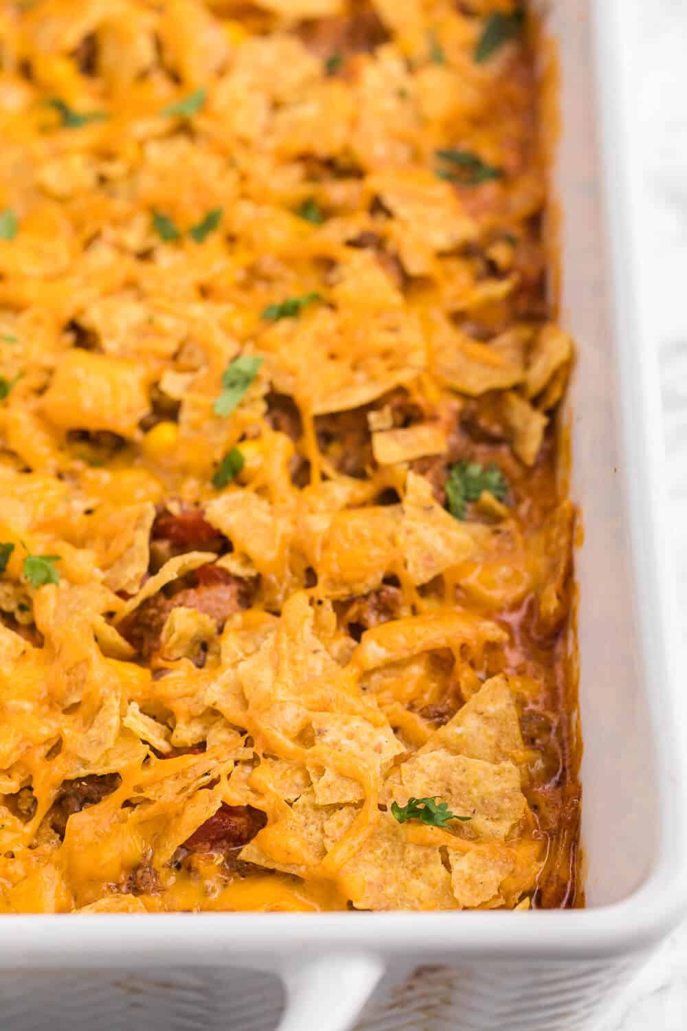 Beef nacho bake in a white casserole dish.