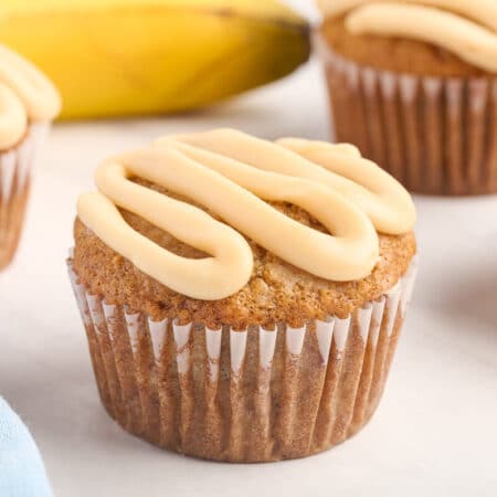 A caramel banana muffin on a white surface.