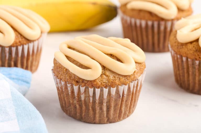 A caramel banana muffin on a white surface.