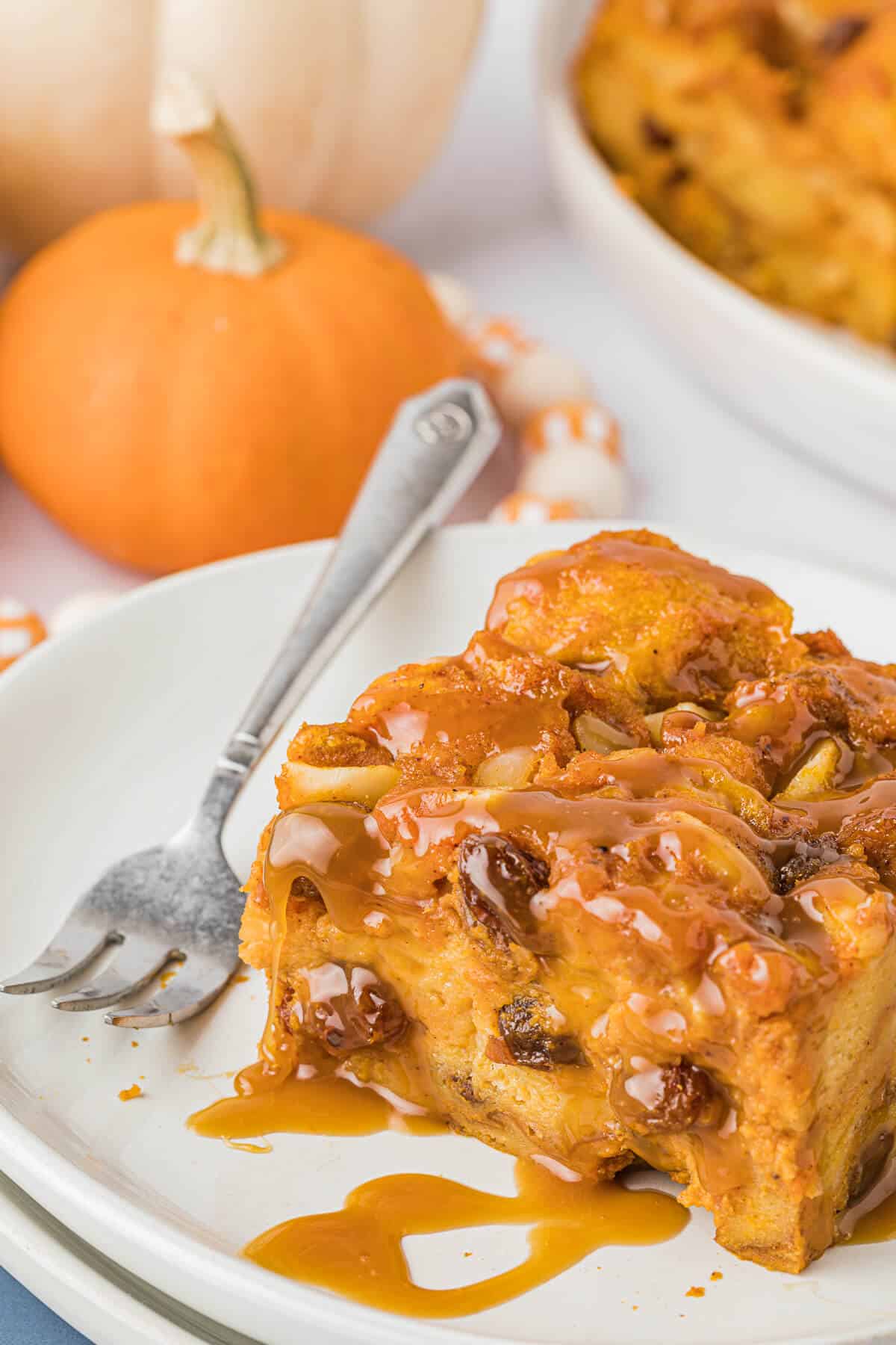 A piece of pumpkin bread pudding on a plate.