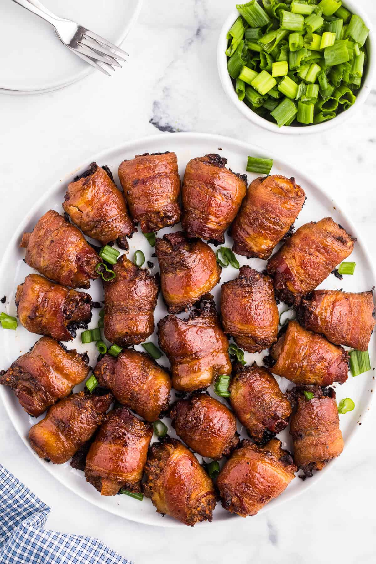 Stuffed bacon rolls on a plate.