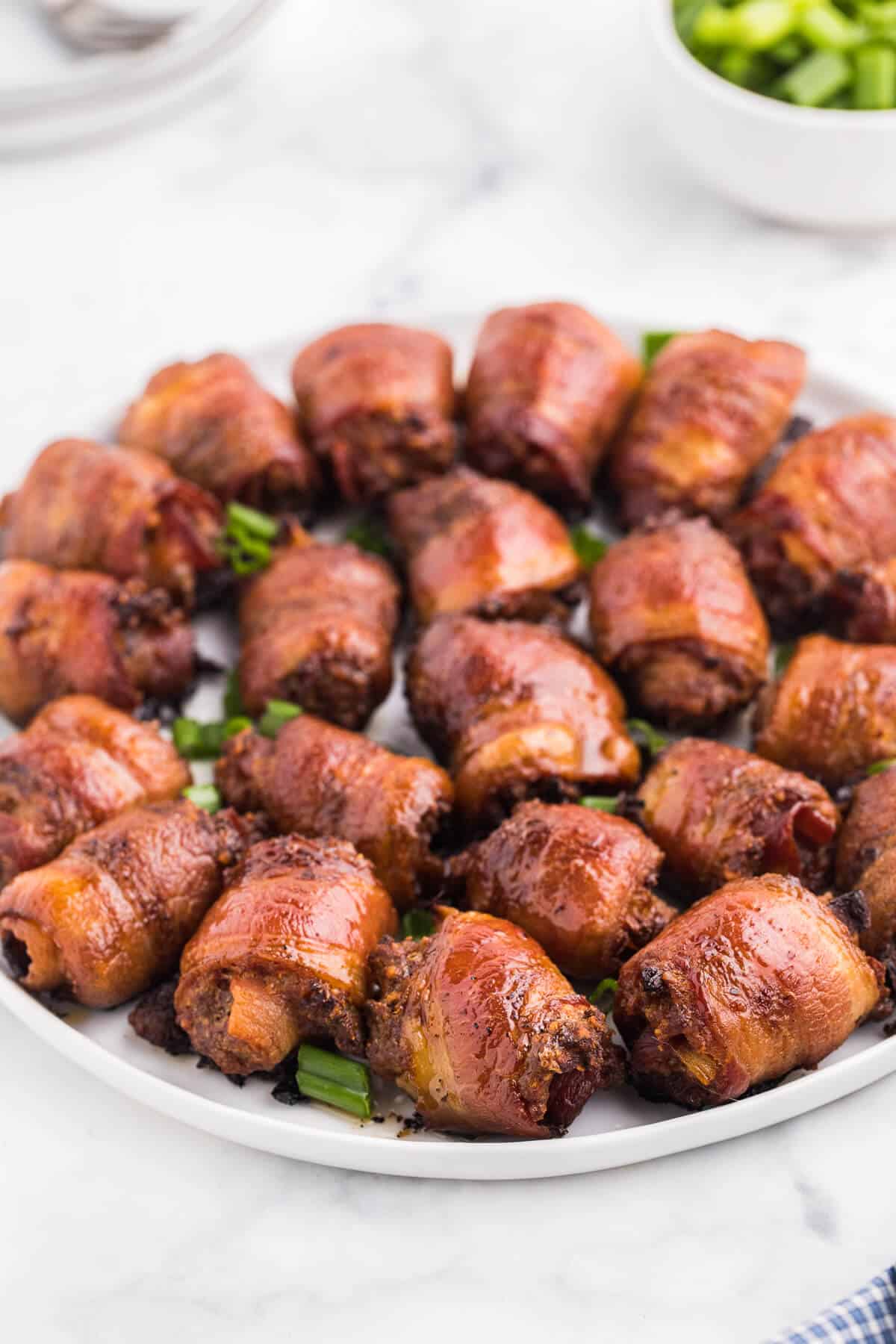 Photo of bacon rolls on a white plate