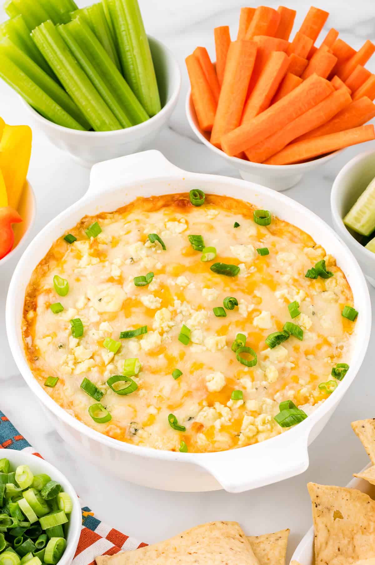 Buffalo chicken dip surrounded by fresh veggies.