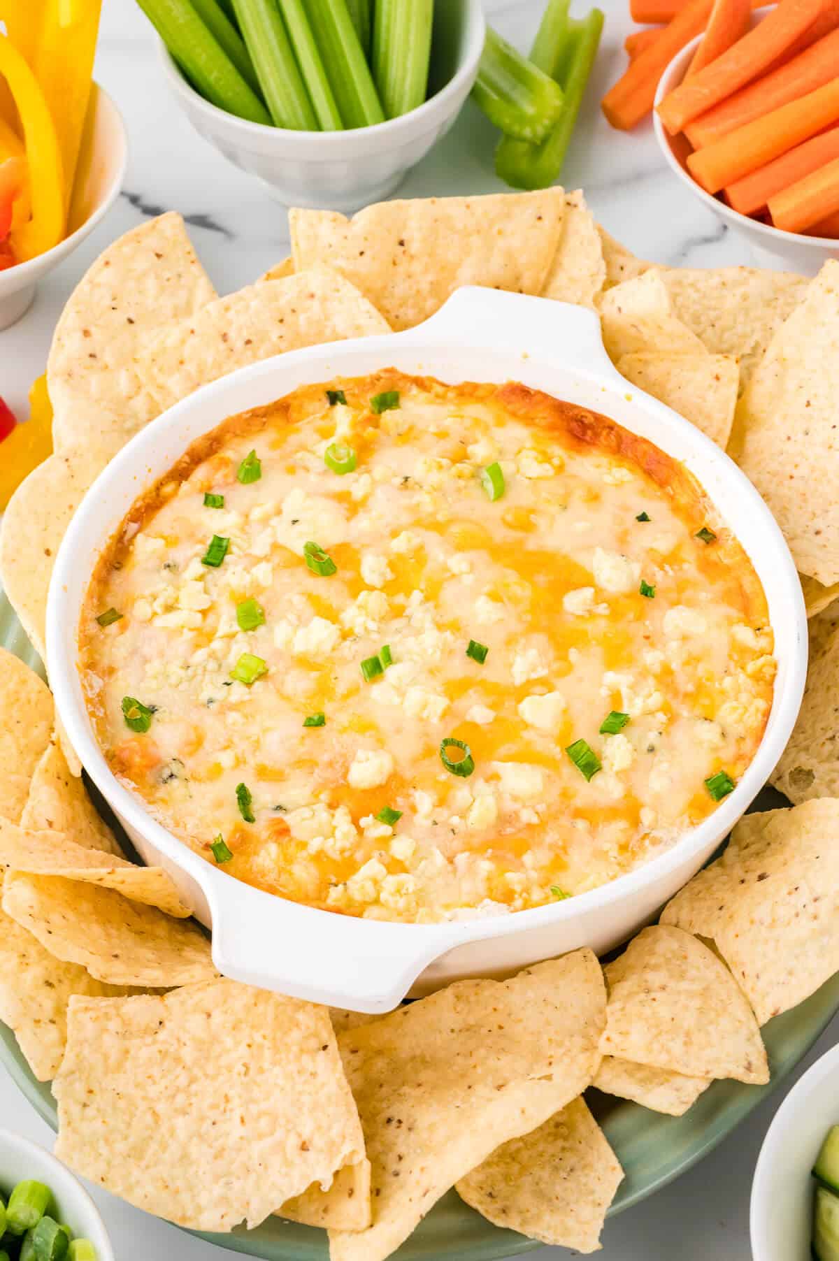 Buffalo chicken dip surrounded by tortilla chips.