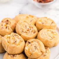 Cheesy Bacon Pinwheels - A dreamy holiday appetizer! Fluffy crescent rolls stuffed with bacon, onion, and two cheeses for a snack that's enough for a meal.