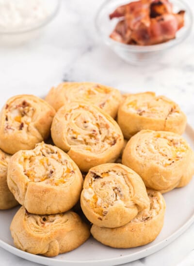Cheesy Bacon Pinwheels - A dreamy holiday appetizer! Fluffy crescent rolls stuffed with bacon, onion, and two cheeses for a snack that's enough for a meal.