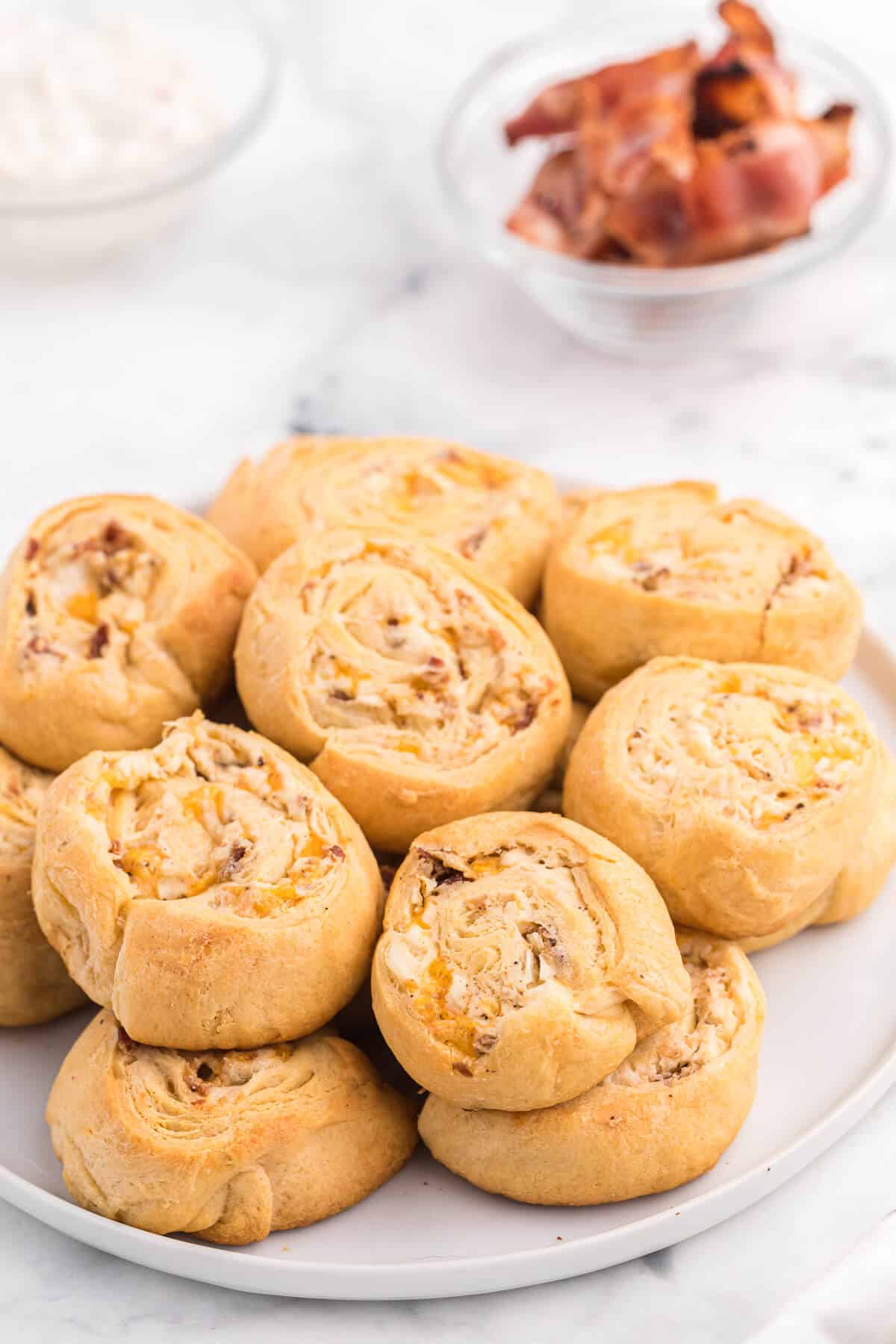 Cheesy Bacon Pinwheels - A dreamy holiday appetizer! Fluffy crescent rolls stuffed with bacon, onion, and two cheeses for a snack that's enough for a meal.