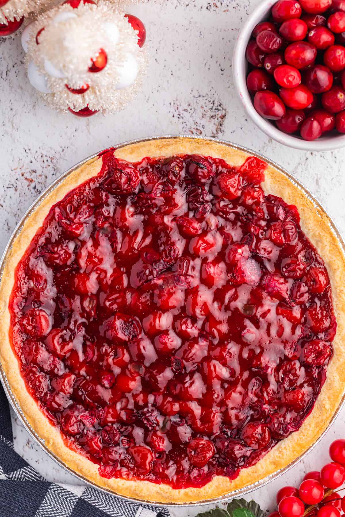 Cherry Cranberry Pie surrounded by Christmas decor.