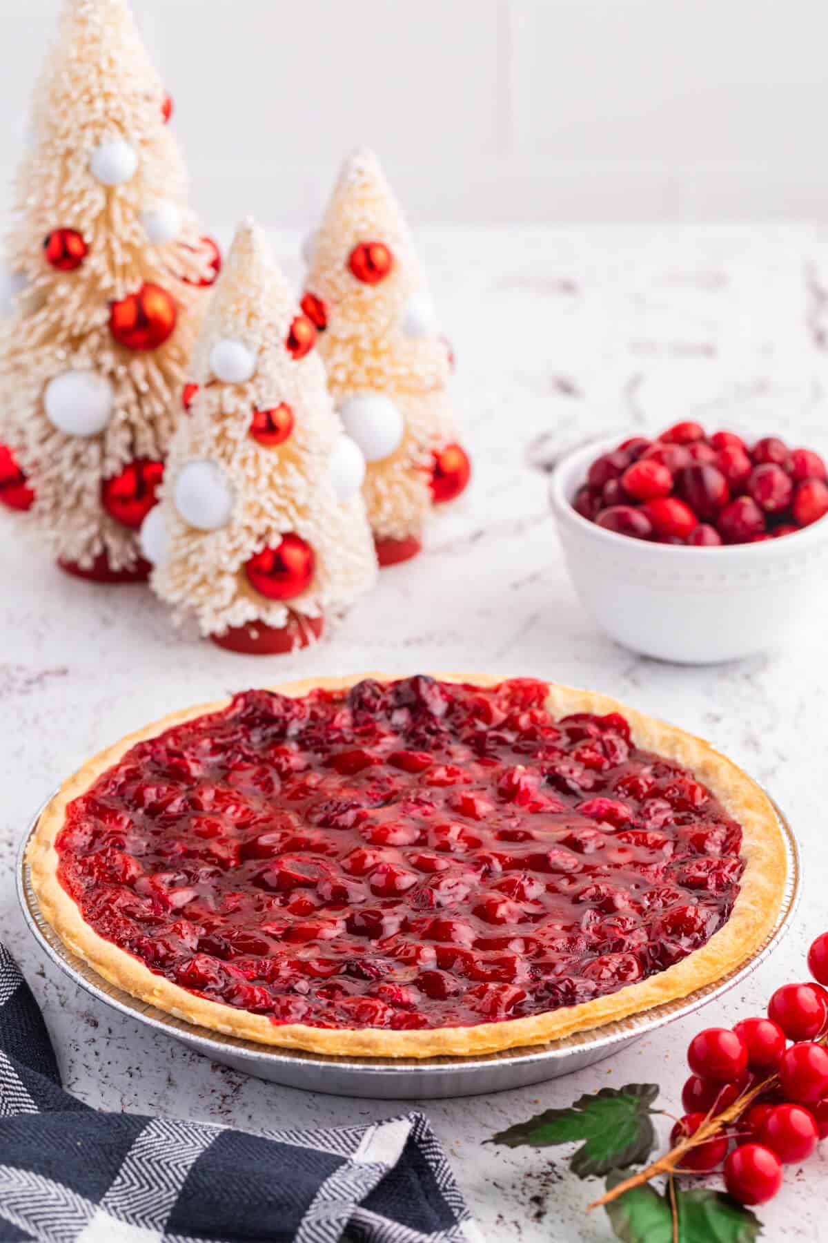 Cherry Cranberry Pie surrounded by Christmas decor.