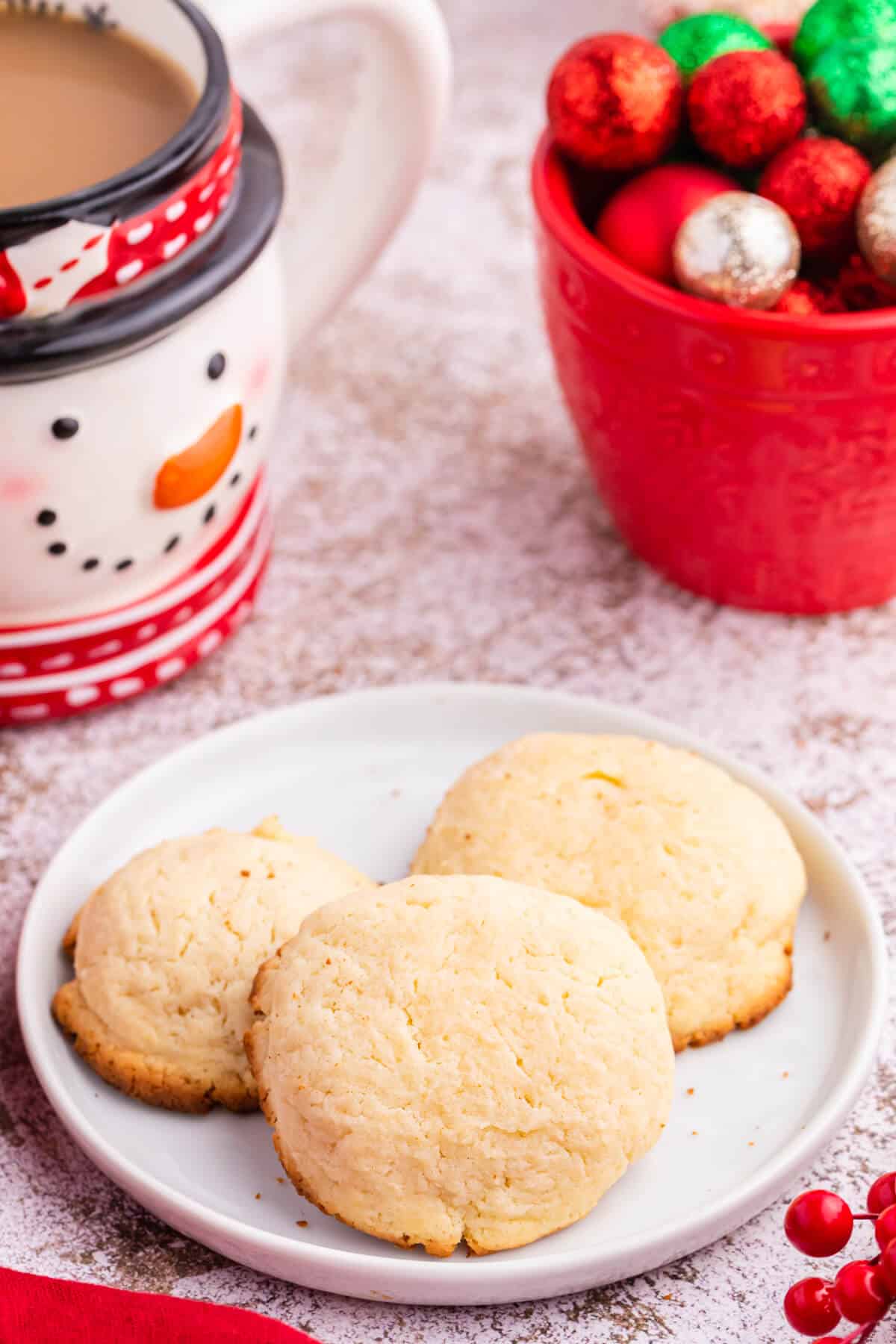 Three cream cheese cookies on a plate.