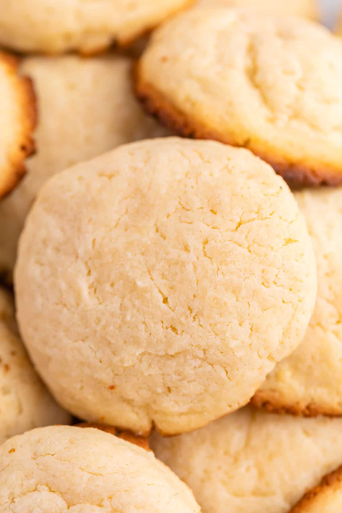 A pile of cream cheese cookies on a plate.