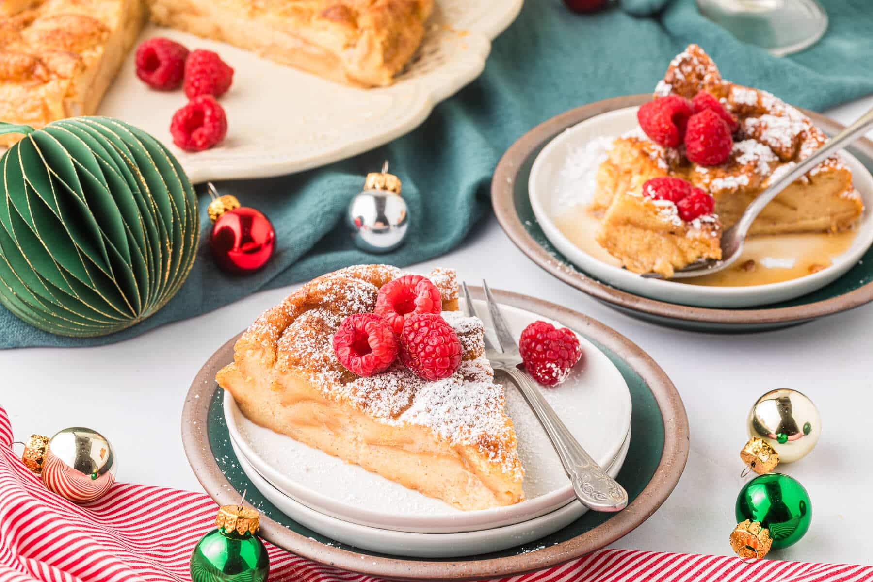 A slice of eggnog bread pudding on a plate with a fork.