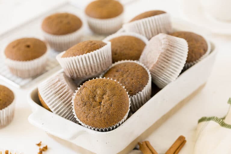 Gingerbread muffins in a white container.