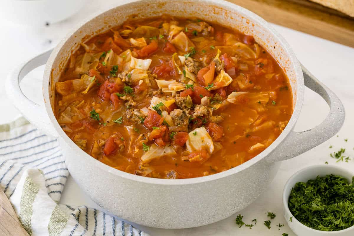 Sausage and cabbage soup in a pot.