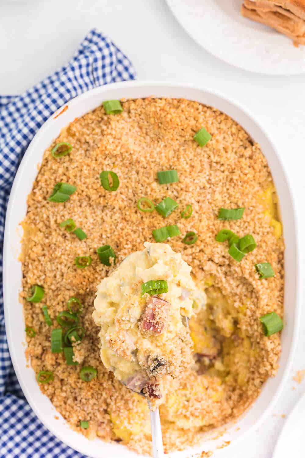 Scrambled Egg Casserole - Soft oven-scrambled eggs with ham, green onion, cheddar and mushrooms are baked under a crispy, toasted layer of bread crumbs. A delicious and decadent change from bread-based breakfast casseroles.
