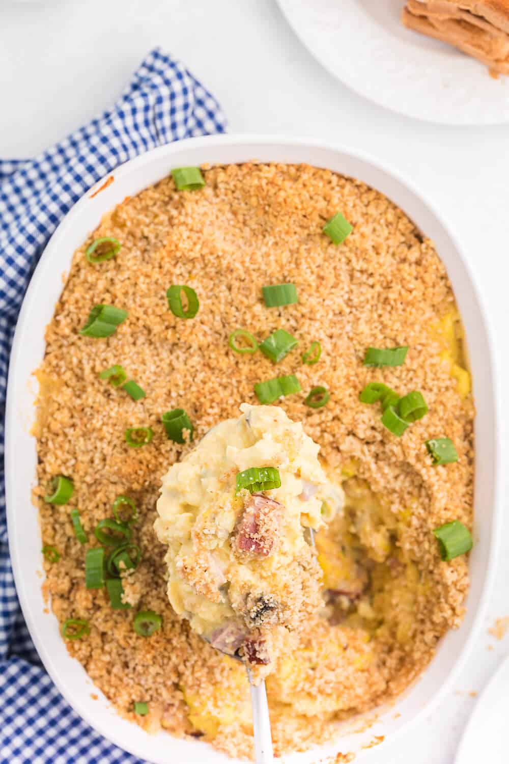 A scoop of scrambled egg casserole on a serving spoon.