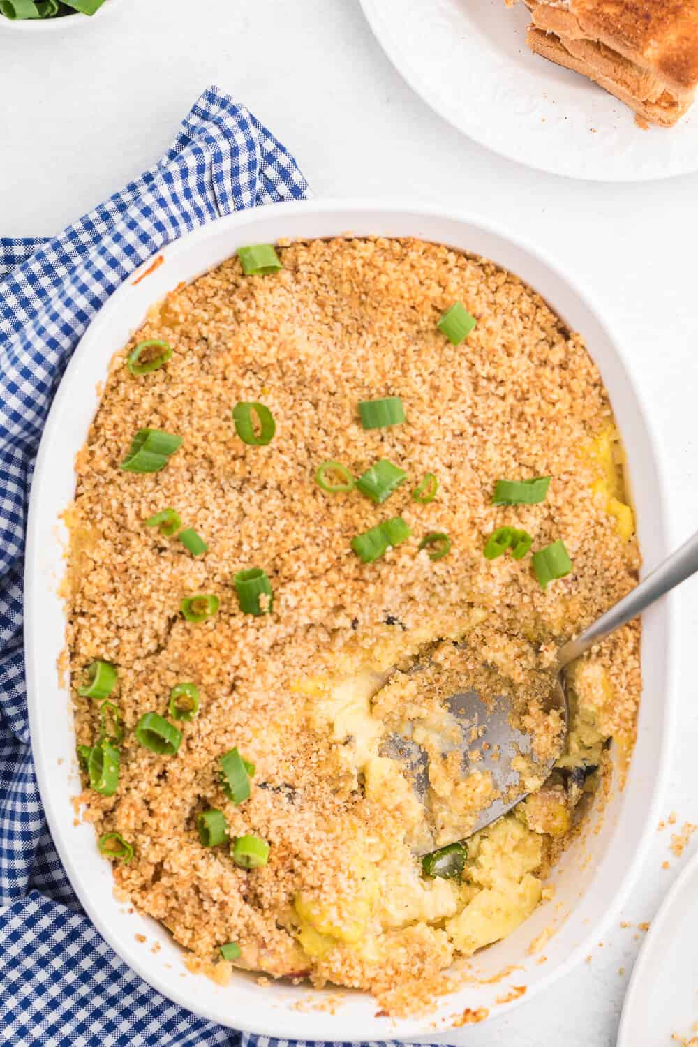 Scrambled Egg Casserole - Soft oven-scrambled eggs with ham, green onion, cheddar and mushrooms are baked under a crispy, toasted layer of bread crumbs. A delicious and decadent change from bread-based breakfast casseroles.