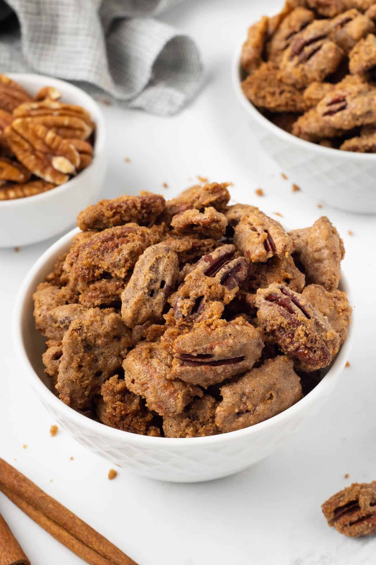Sweet spiced pecans in a white bowl.