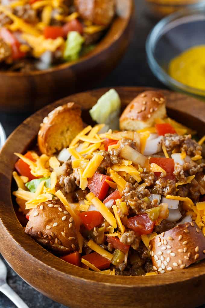 Cheeseburger Salad - The best burger salad recipe! Skip the bun and add cheesy ground beef, tomatoes, and hamburger bun croutons to this filling dinner salad.