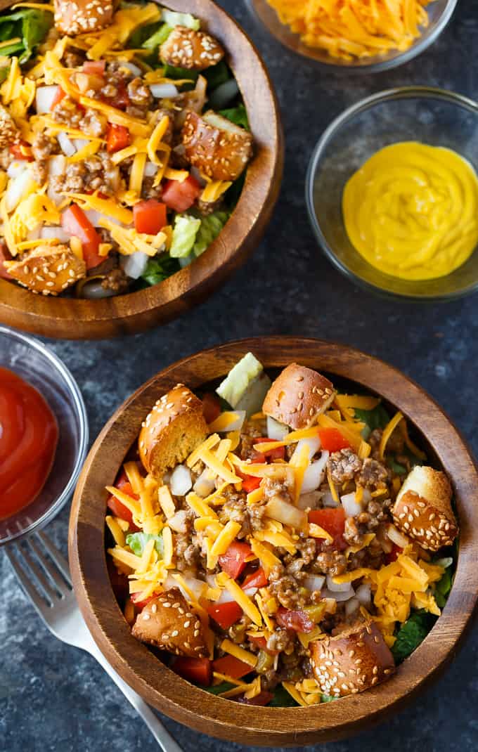 Cheeseburger Salad - The best burger salad recipe! Skip the bun and add cheesy ground beef, tomatoes, and hamburger bun croutons to this filling dinner salad.