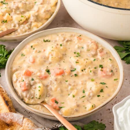 Cheeseburger chowder in a bowl with a spoon.