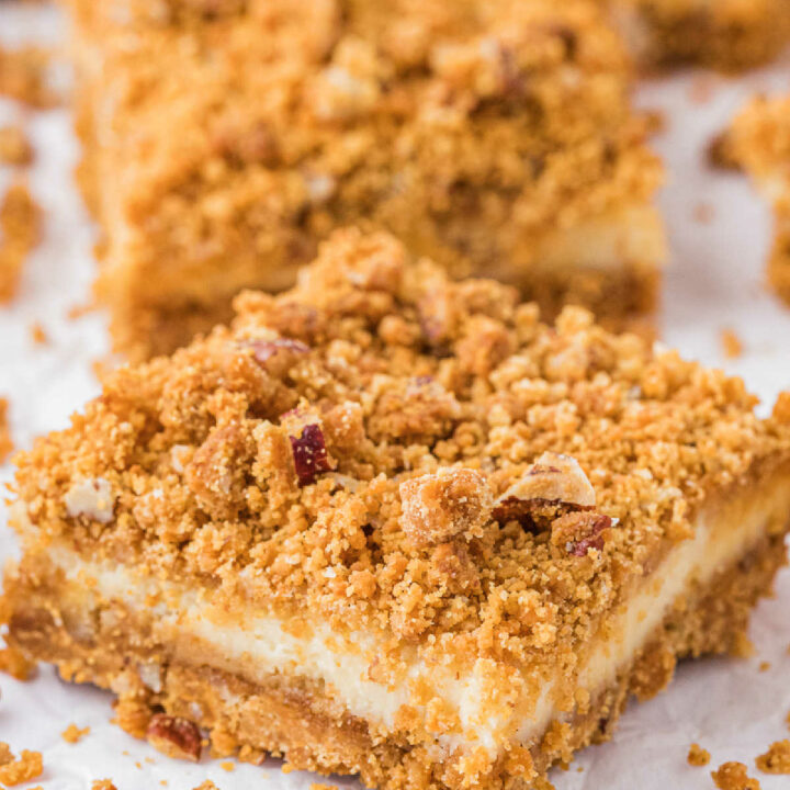 Butterscotch cheesecake bars on a piece of parchment paper.
