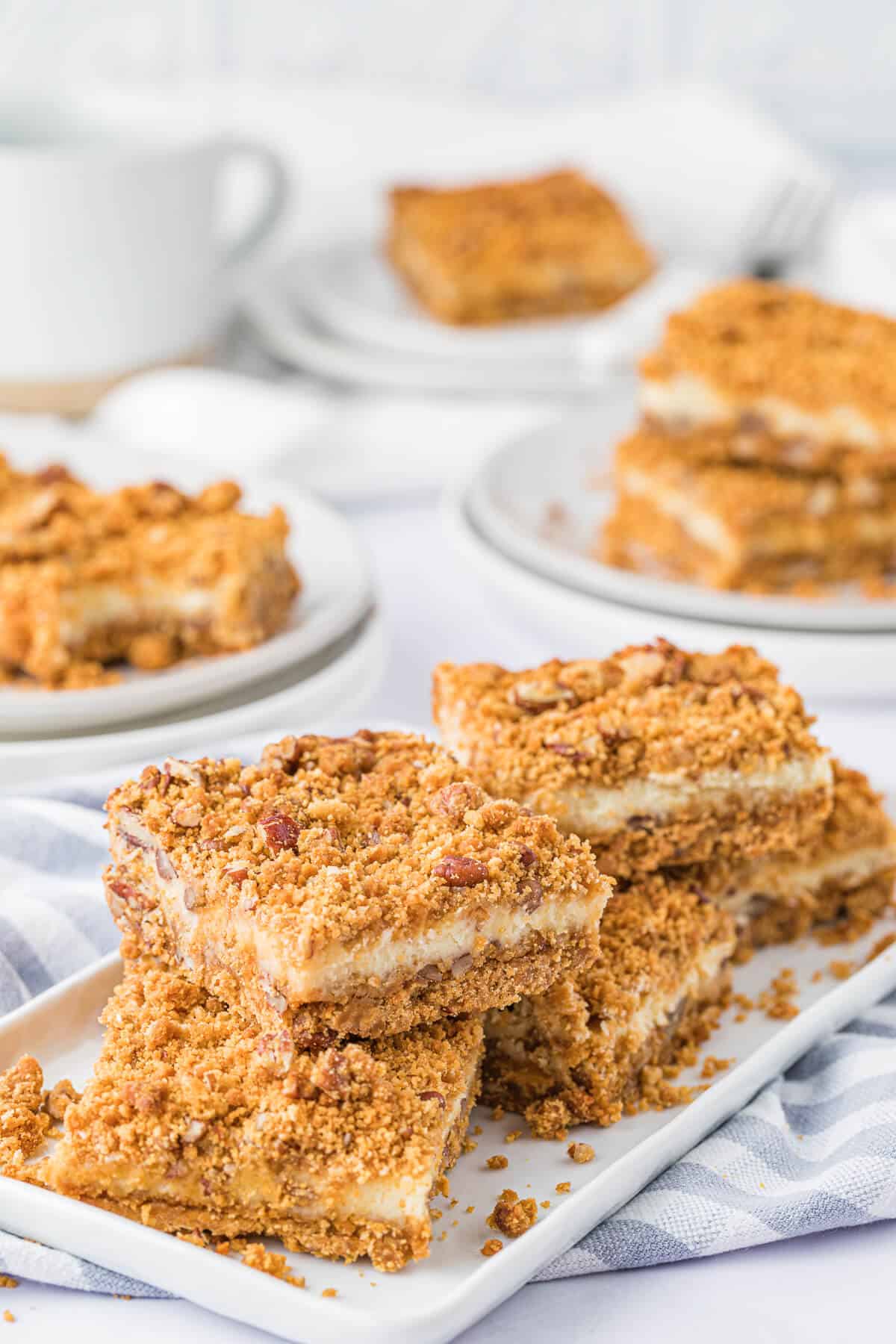 A group of butterscotch cheesecake bars on a platter.