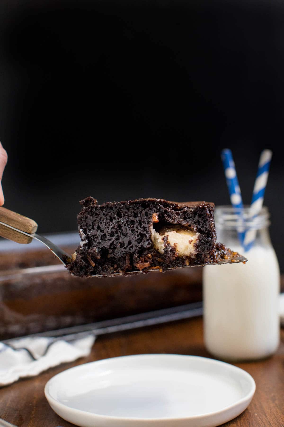 A slice of earthquake cake on a spatula.