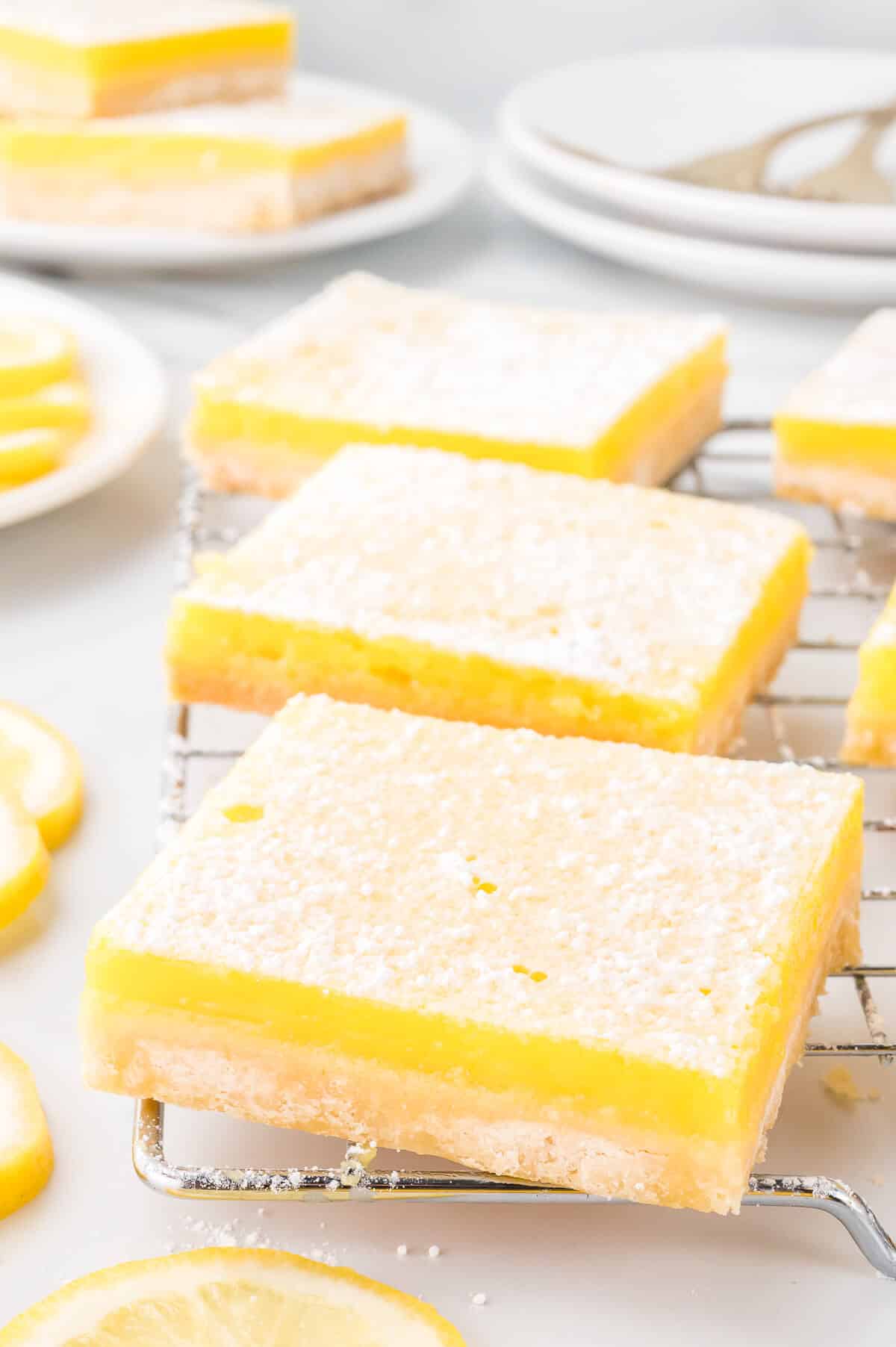 Lemon bars on a wire rack.