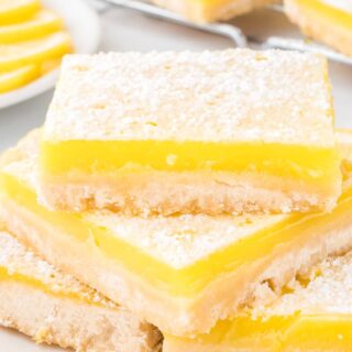 A stack of lemon bars on a plate.