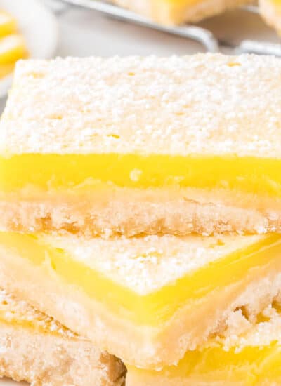 A stack of lemon bars on a plate.