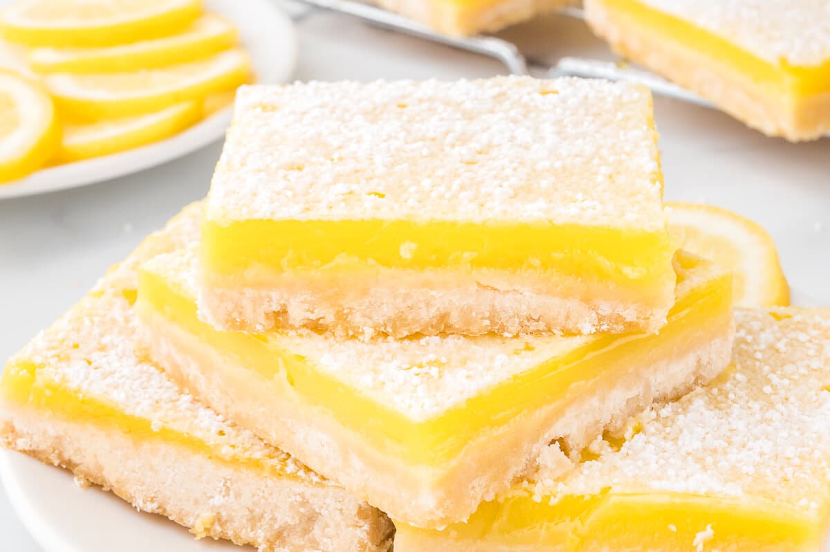 A stack of lemon bars on a plate.