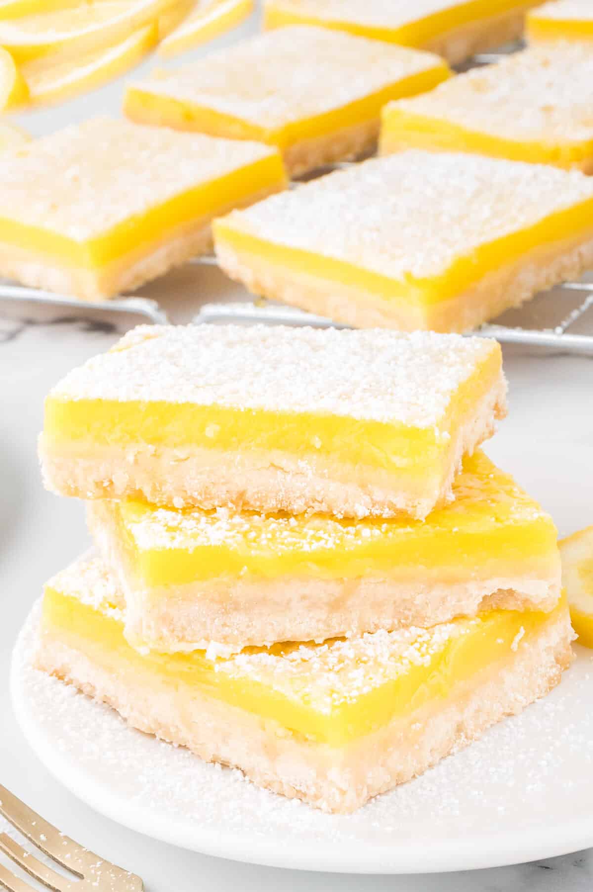 A stack of lemon bars on a plate.