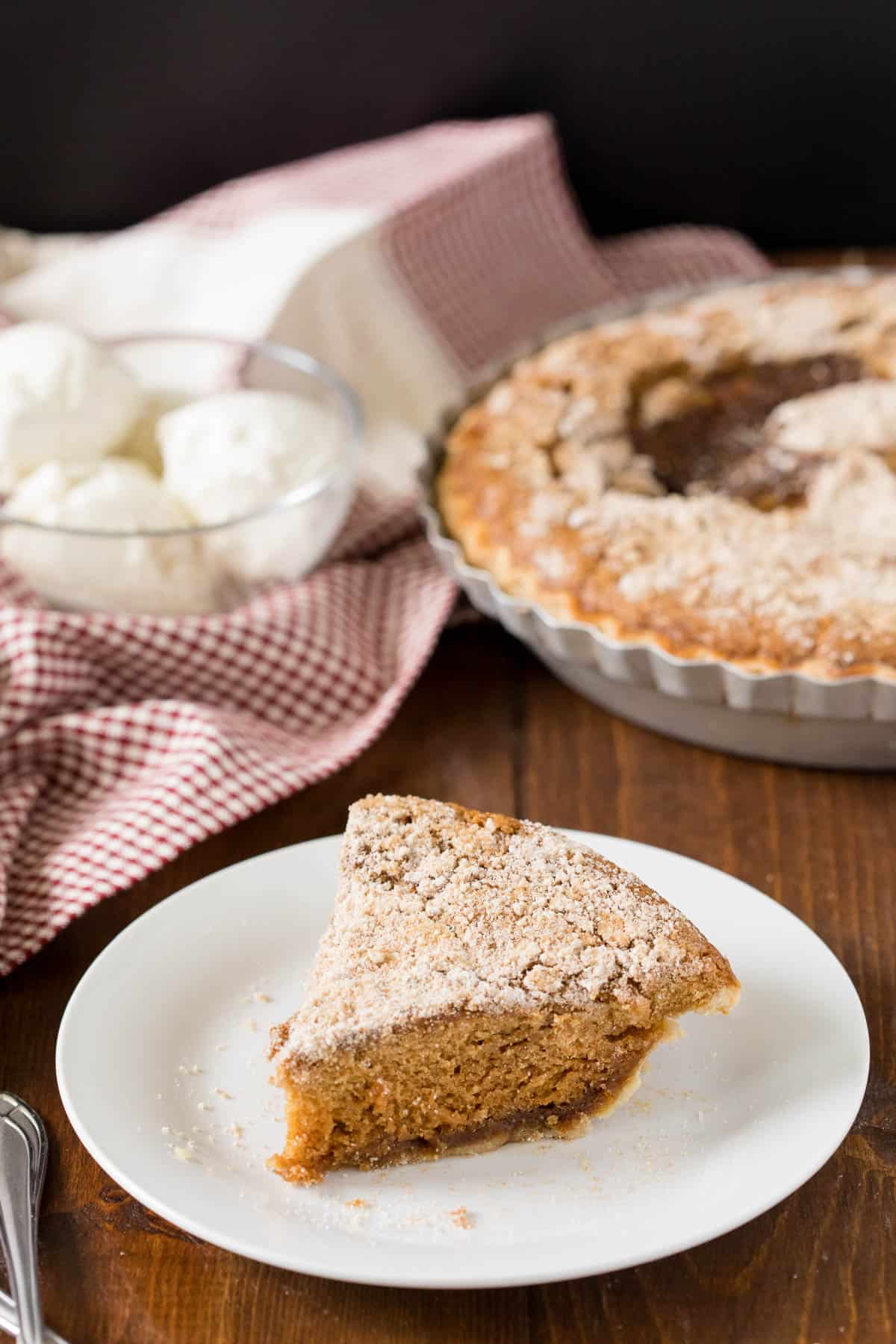 A slice of pie on a plate.
