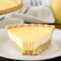 A slice of pie on a plate with a bite off the end.