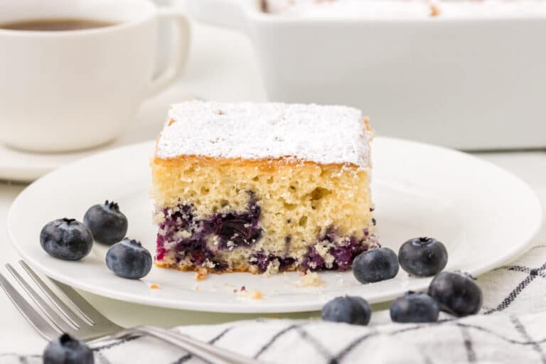 A slice of blueberry tea cake on a plate.