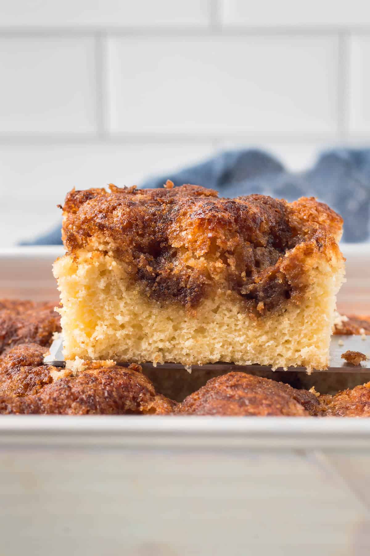 Grandma's cinnamon coffee cake slice on a cake pan.